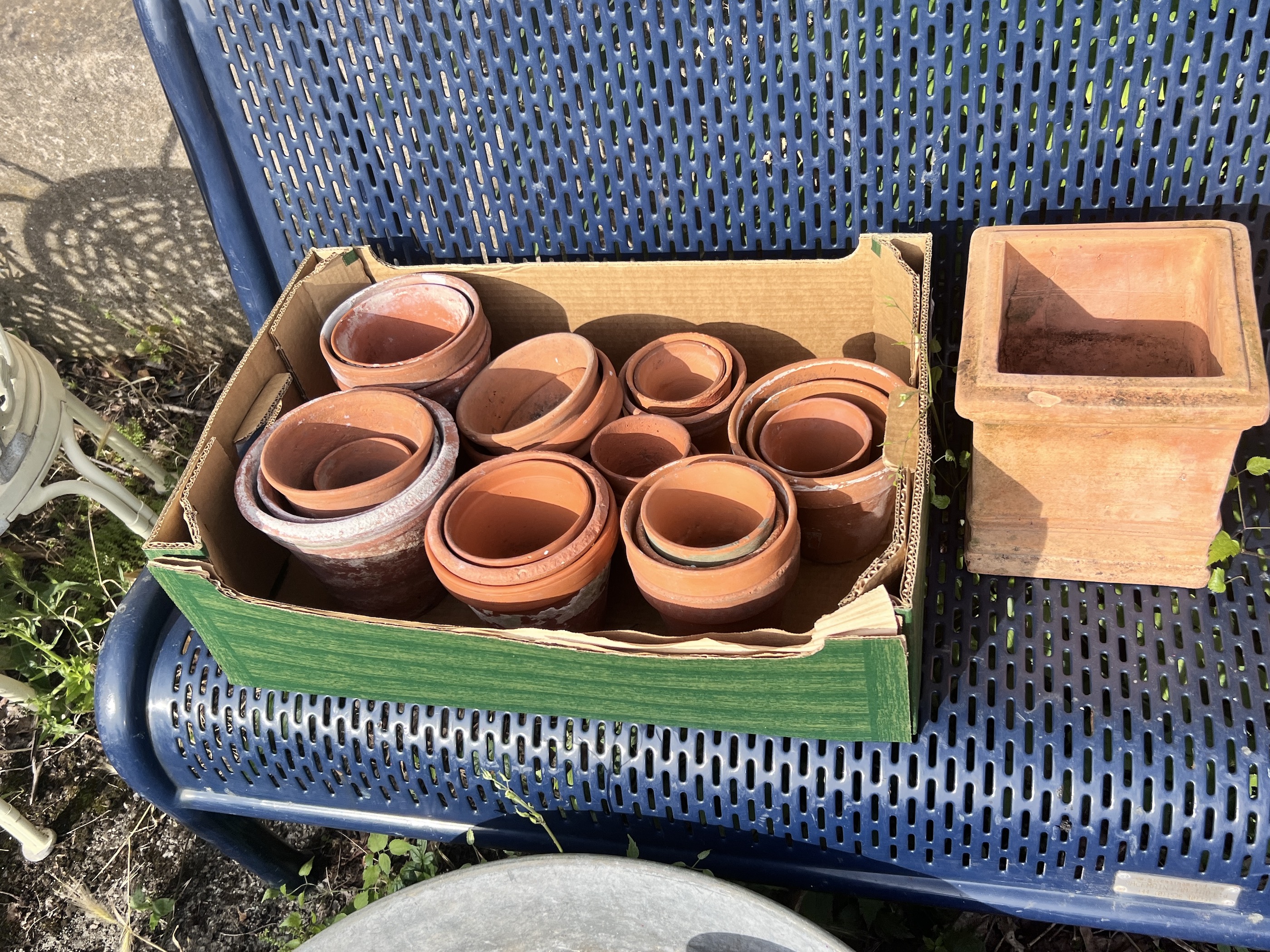 A large circular galvanised tub, diameter 72cm, together with a quantity of assorted terracotta garden pots